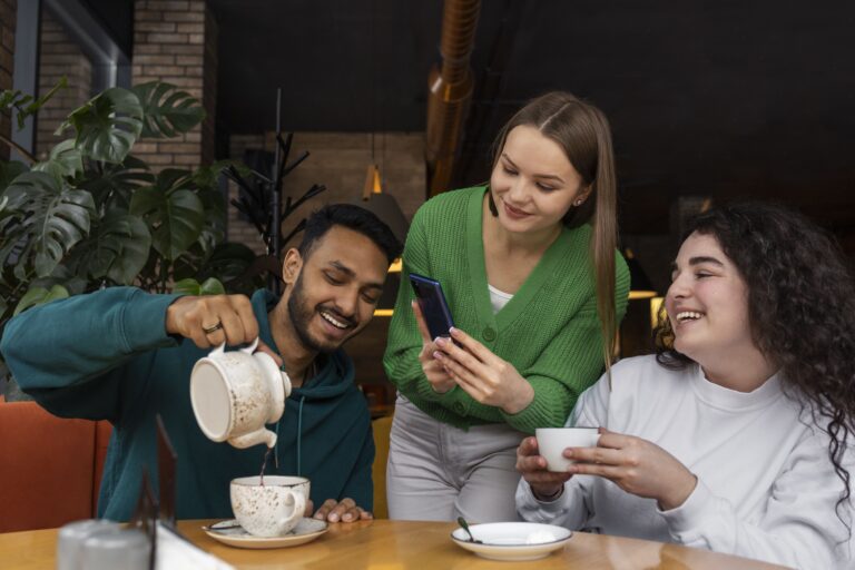 medium-shot-smiley-friends-with-smartphone